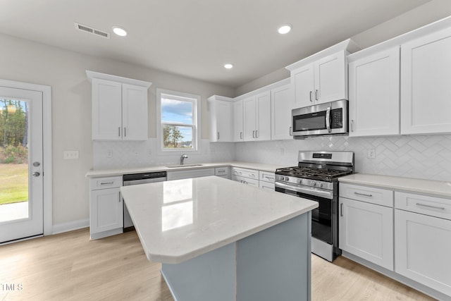 kitchen featuring white cabinets, plenty of natural light, and appliances with stainless steel finishes