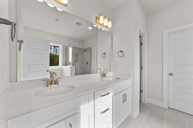 bathroom with walk in shower, tile patterned flooring, and vanity