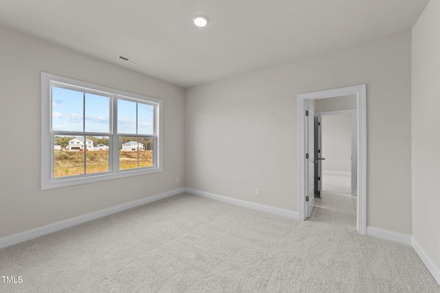 spare room with light colored carpet