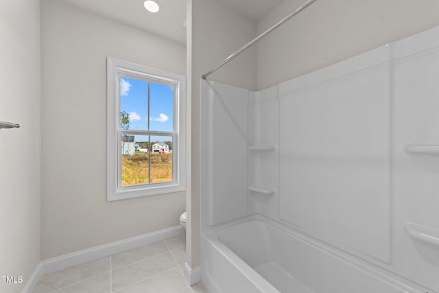 bathroom with toilet, shower / bathing tub combination, and tile patterned flooring