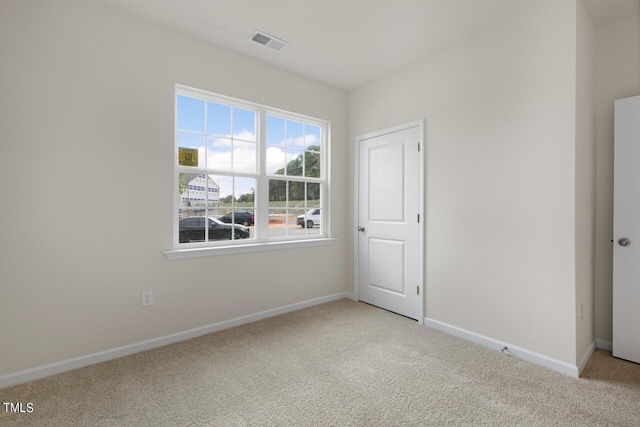 empty room with light colored carpet