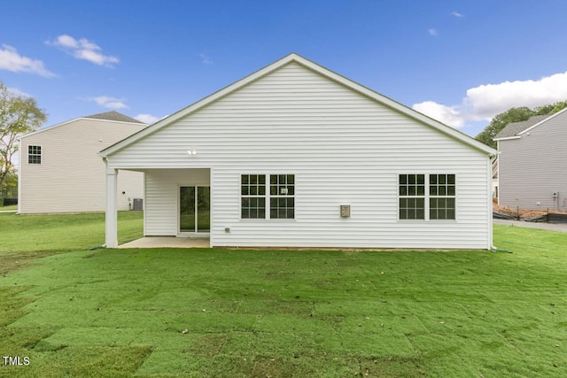 back of property featuring a yard and a patio