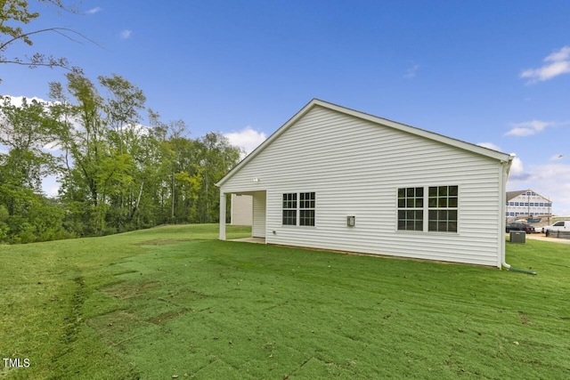 rear view of property with a yard