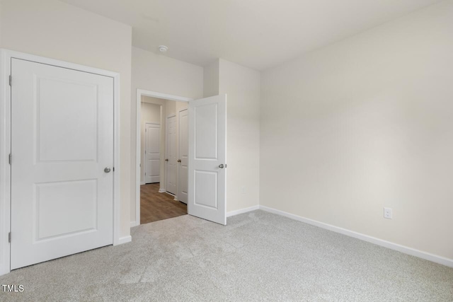 unfurnished bedroom featuring light carpet