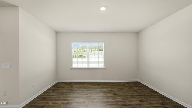 unfurnished room with dark hardwood / wood-style flooring