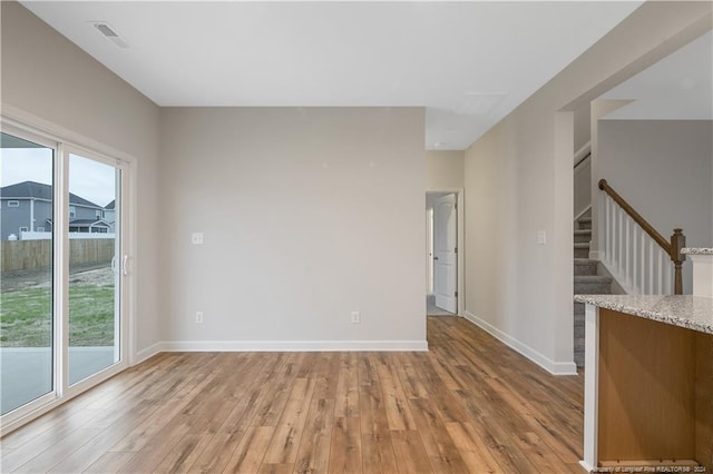 empty room with light hardwood / wood-style floors