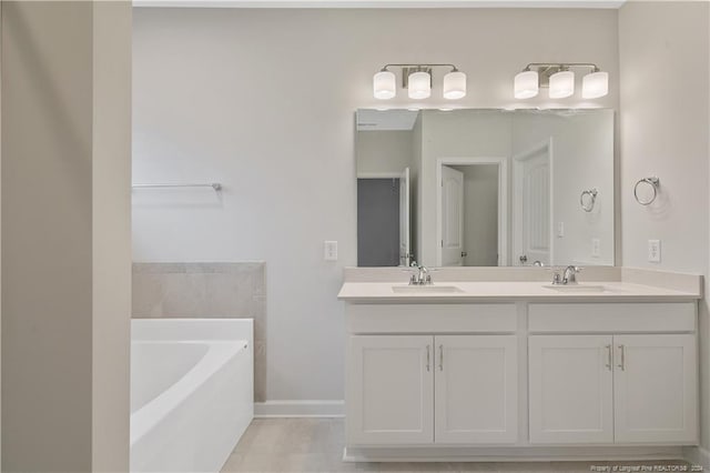 bathroom with tile patterned flooring, a washtub, and vanity
