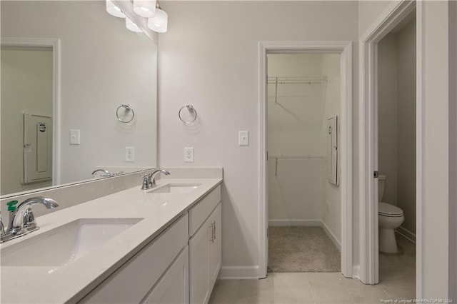 bathroom with tile patterned flooring, vanity, and toilet