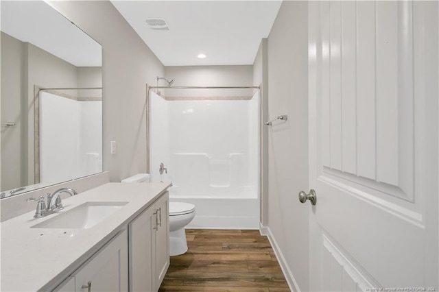 full bathroom featuring bathing tub / shower combination, toilet, vanity, and hardwood / wood-style flooring