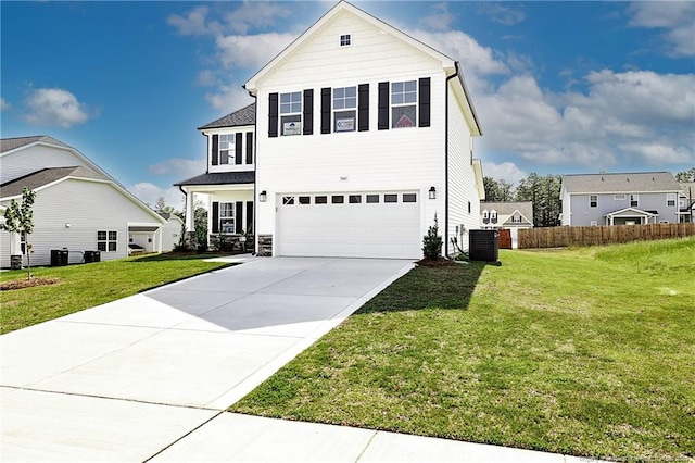  - traditional home featuring an attached garage, driveway, and central AC