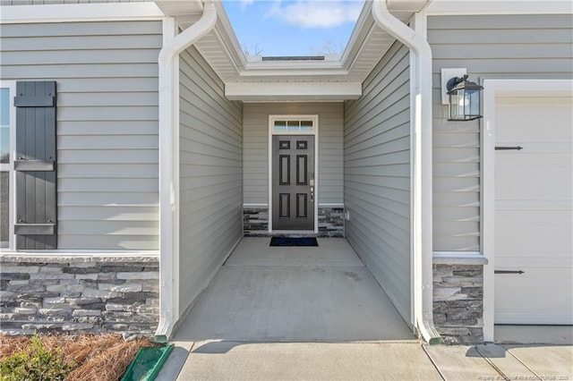 doorway to property with stone siding