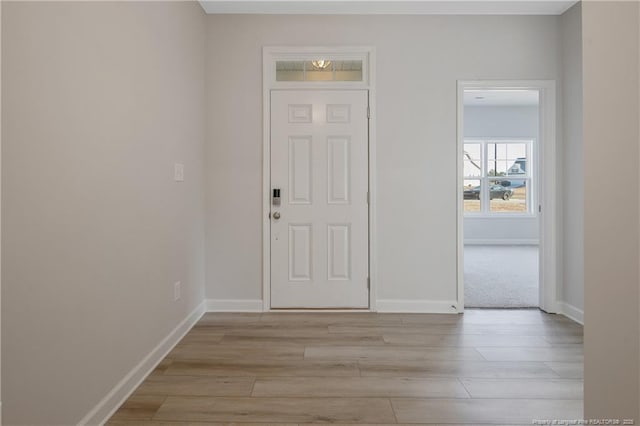 entrance foyer featuring light wood-style floors and baseboards