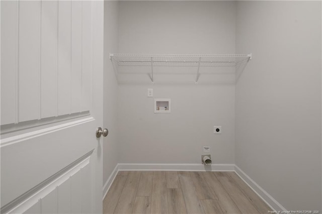 clothes washing area with laundry area, baseboards, hookup for an electric dryer, light wood-type flooring, and washer hookup