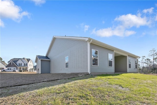 view of side of home with a yard