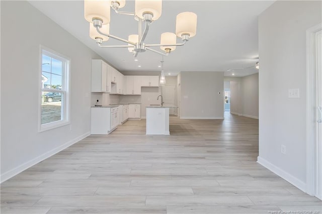 5513 Tall Timbers Dr, Fayetteville, NC 28311 - kitchen with a chandelier, open floor plan, healthy amount of natural light, white cabinetry, and recessed lighting