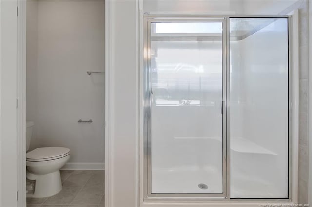 5513 Tall Timbers Dr, Fayetteville, NC 28311 - bathroom with tile patterned flooring, a shower stall, toilet, and baseboards