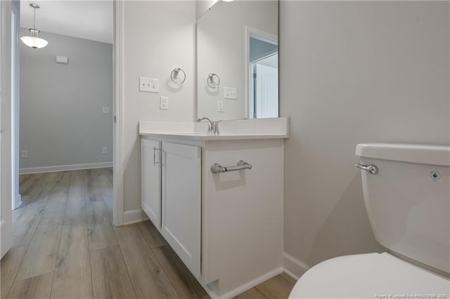 5513 Tall Timbers Dr, Fayetteville, NC 28311 - bathroom featuring toilet, wood finished floors, vanity, and baseboards