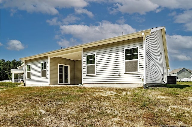 5513 Tall Timbers Dr, Fayetteville, NC 28311 - rear view of property with central air condition unit and a lawn