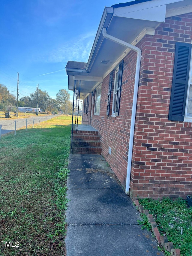 view of home's exterior with a lawn