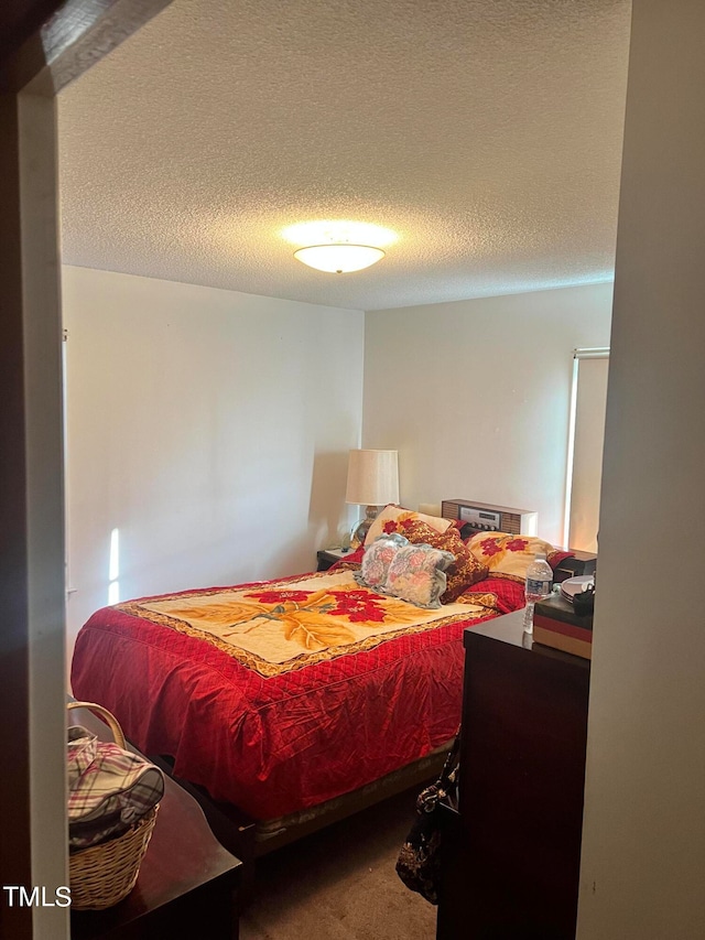 carpeted bedroom with a textured ceiling