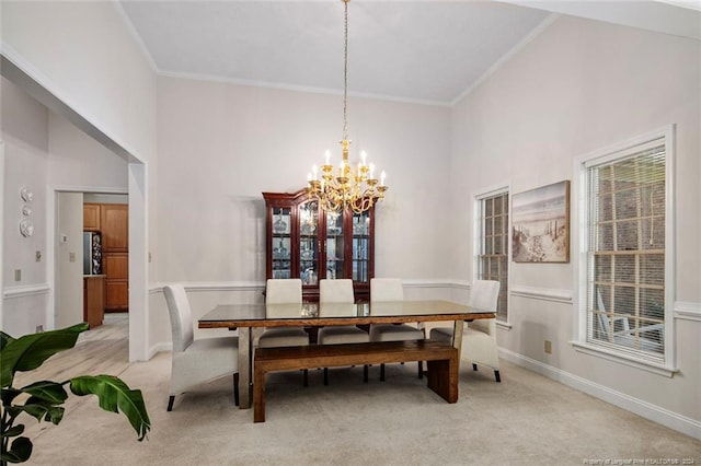 dining space with light carpet, high vaulted ceiling, ornamental molding, and a notable chandelier