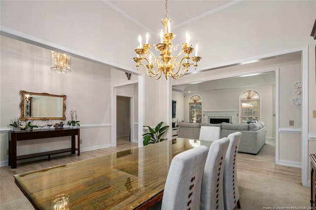 dining area with a chandelier, light hardwood / wood-style flooring, and ornamental molding