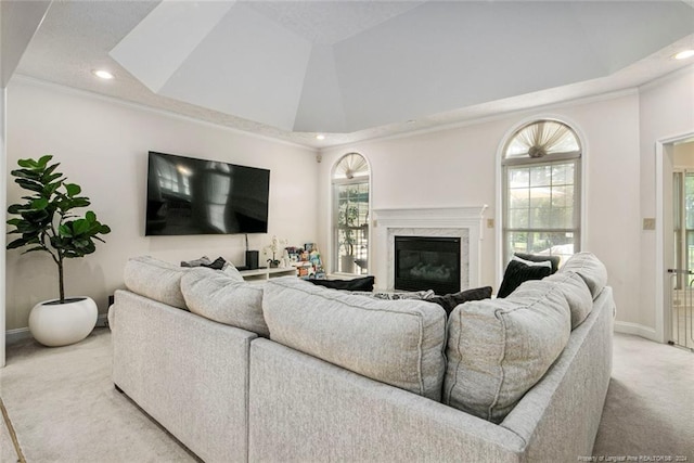 carpeted living room with crown molding and a fireplace