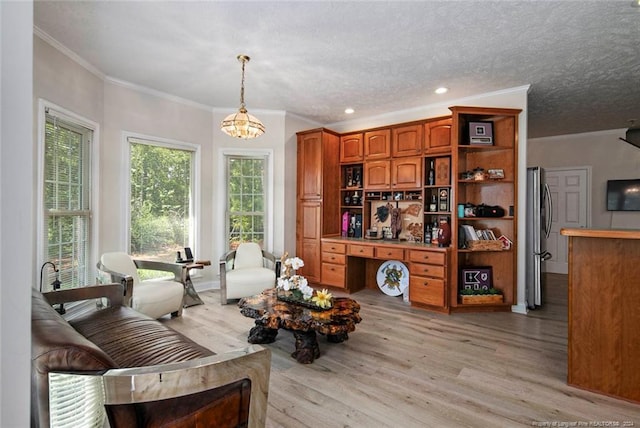 living room featuring ornamental molding, a healthy amount of sunlight, and light wood-type flooring