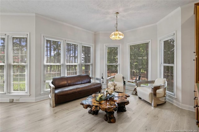 sunroom / solarium with a wealth of natural light and an inviting chandelier