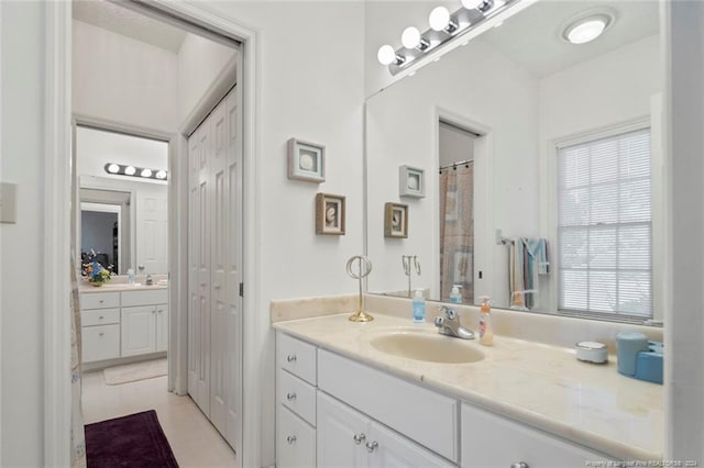 bathroom featuring tile patterned flooring and vanity