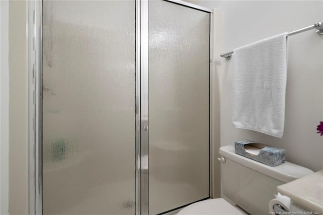 bathroom with toilet and walk in shower