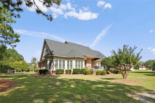 rear view of house featuring a lawn