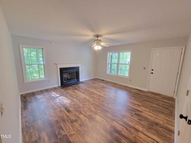 unfurnished living room with a wealth of natural light, hardwood / wood-style flooring, and ceiling fan