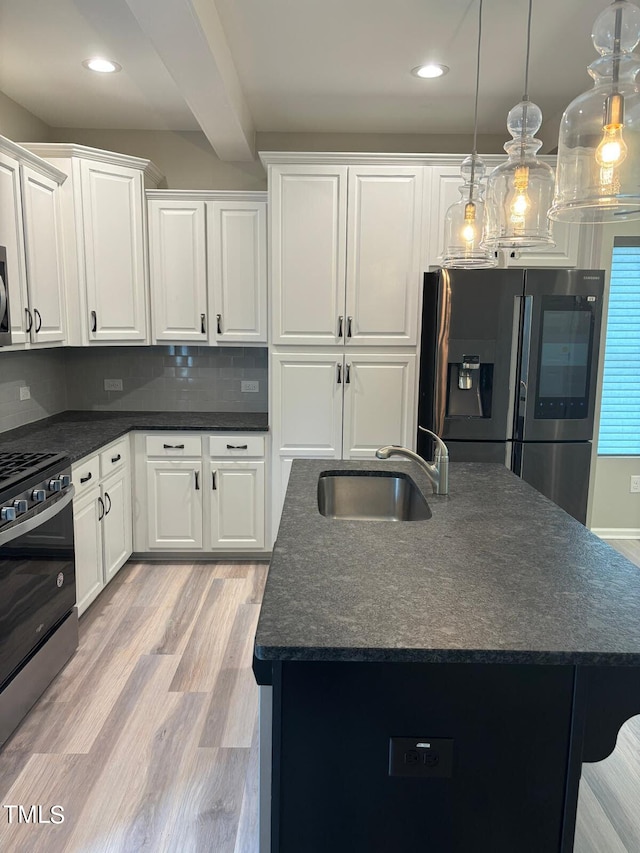 kitchen with light wood-type flooring, white cabinetry, backsplash, stainless steel appliances, and sink