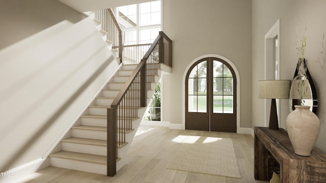 entryway with stairs, french doors, and wood finished floors