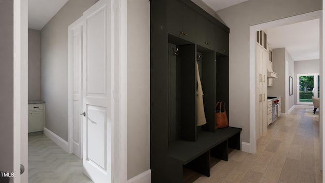 mudroom with parquet floors and baseboards
