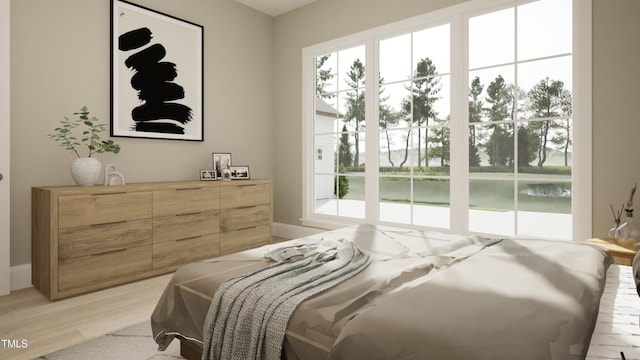 bedroom with access to outside and light wood finished floors