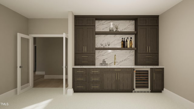 bar with indoor wet bar, light colored carpet, decorative backsplash, beverage cooler, and a sink