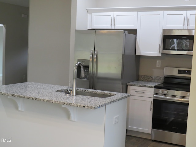 kitchen with white cabinets, stainless steel appliances, and sink