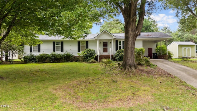 ranch-style home with a storage shed and a front lawn