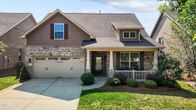 craftsman house with a porch, a garage, and a front lawn