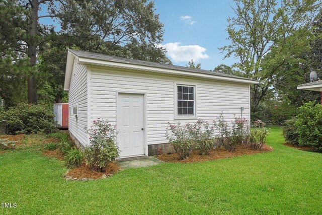 view of outbuilding with a yard