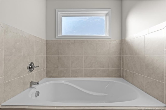 bathroom featuring a relaxing tiled tub