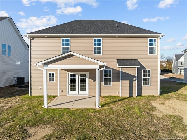 rear view of property with a yard, cooling unit, and a patio area