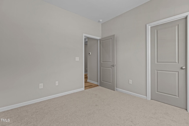 unfurnished bedroom featuring light carpet