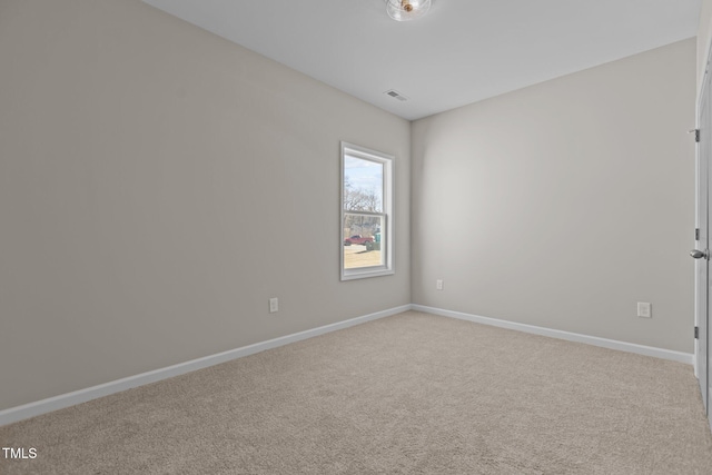 spare room with light colored carpet