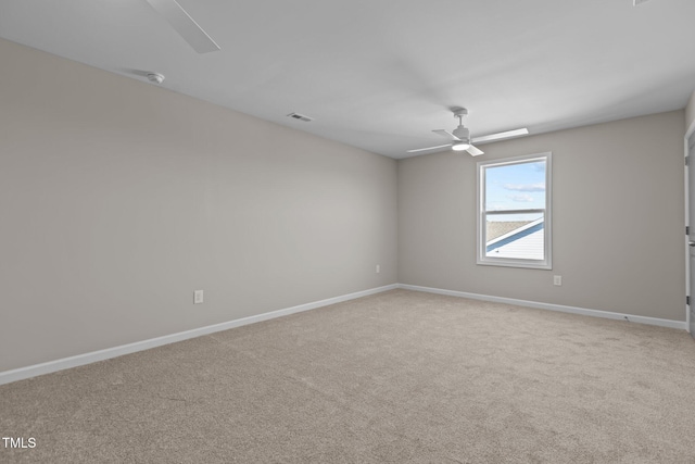 carpeted empty room featuring ceiling fan