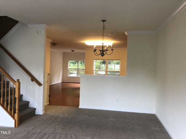 carpeted empty room with ornamental molding and an inviting chandelier