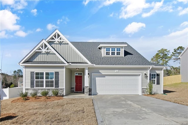 craftsman house with an attached garage, a shingled roof, fence, driveway, and board and batten siding