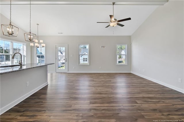 5411 Seedling Rd, Fayetteville, NC 28311 - unfurnished living room with lofted ceiling, a sink, a chandelier, dark wood-style floors, and a ceiling fan